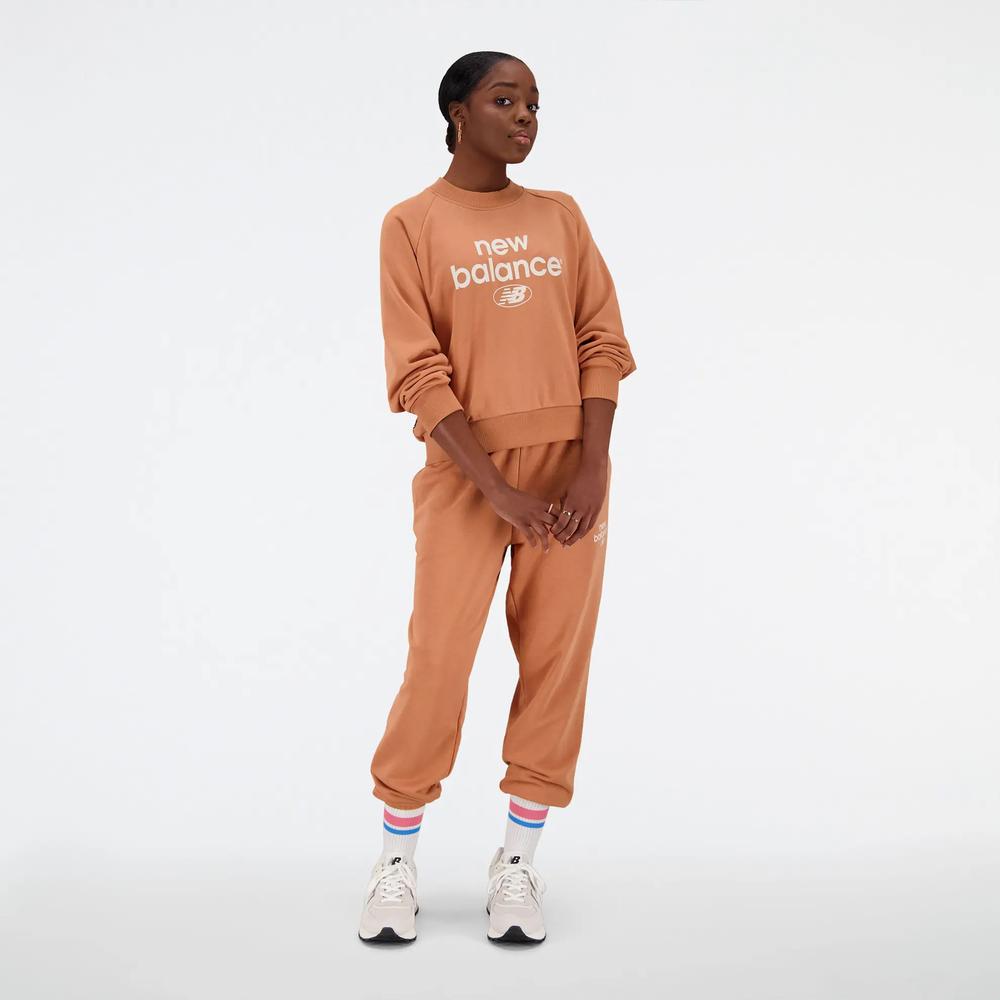 Spodnie New Balance WP31508SEI - pomarańczowe