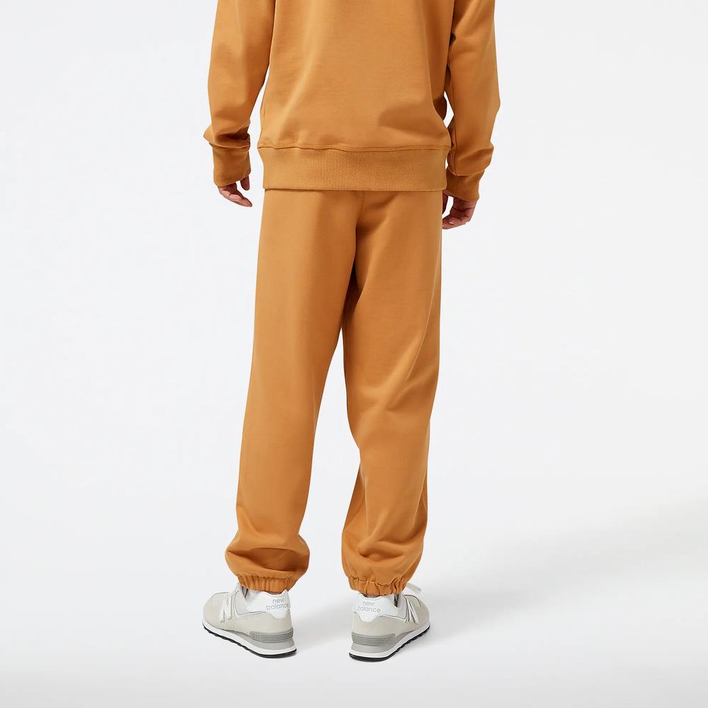 Spodnie dresowe New Balance MP23551TOB - pomarańczowe