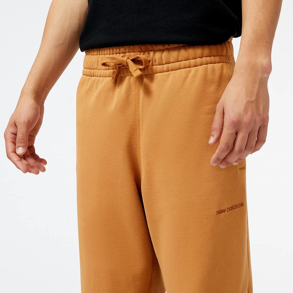 Spodnie dresowe New Balance MP23551TOB - pomarańczowe