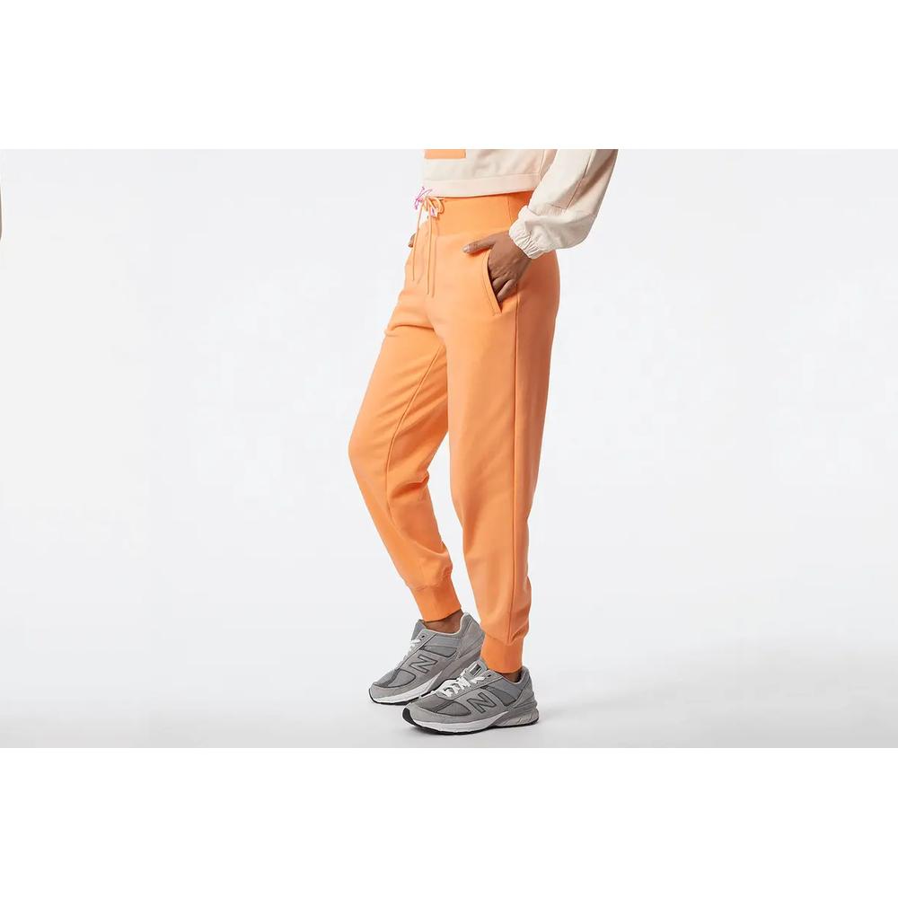 Spodnie dresowe New Balance WP21503PGZ - pomarańczowe