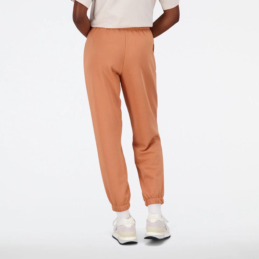 Spodnie New Balance WP31508SEI - pomarańczowe