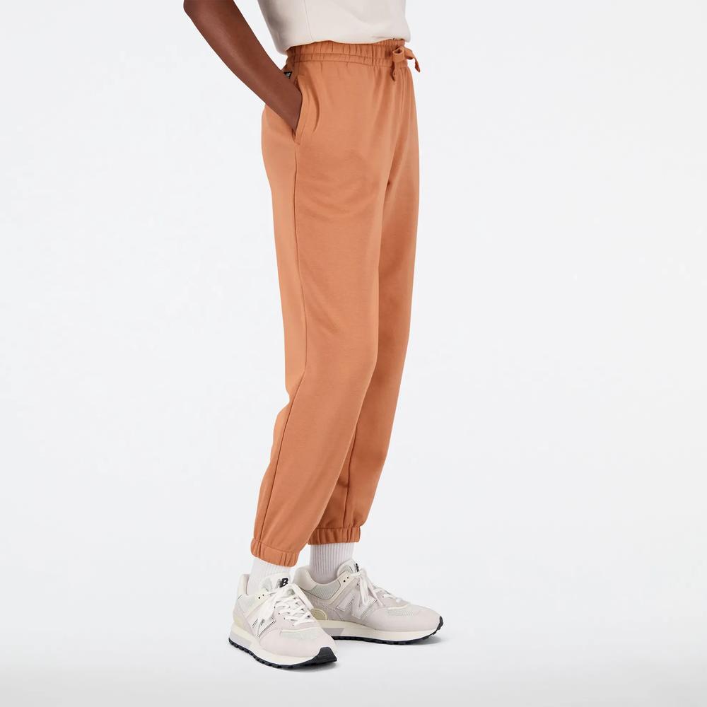 Spodnie New Balance WP31508SEI - pomarańczowe